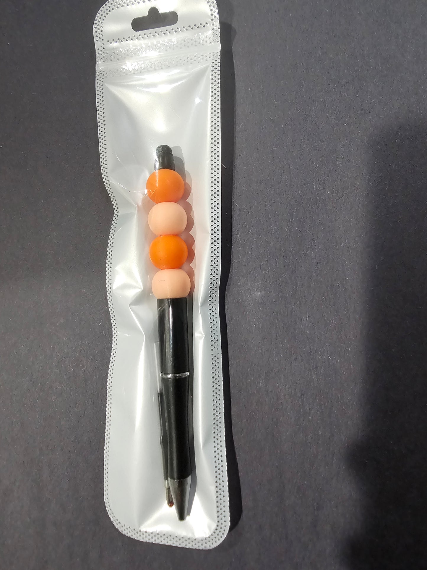 Black, Orange, and Peach Pen